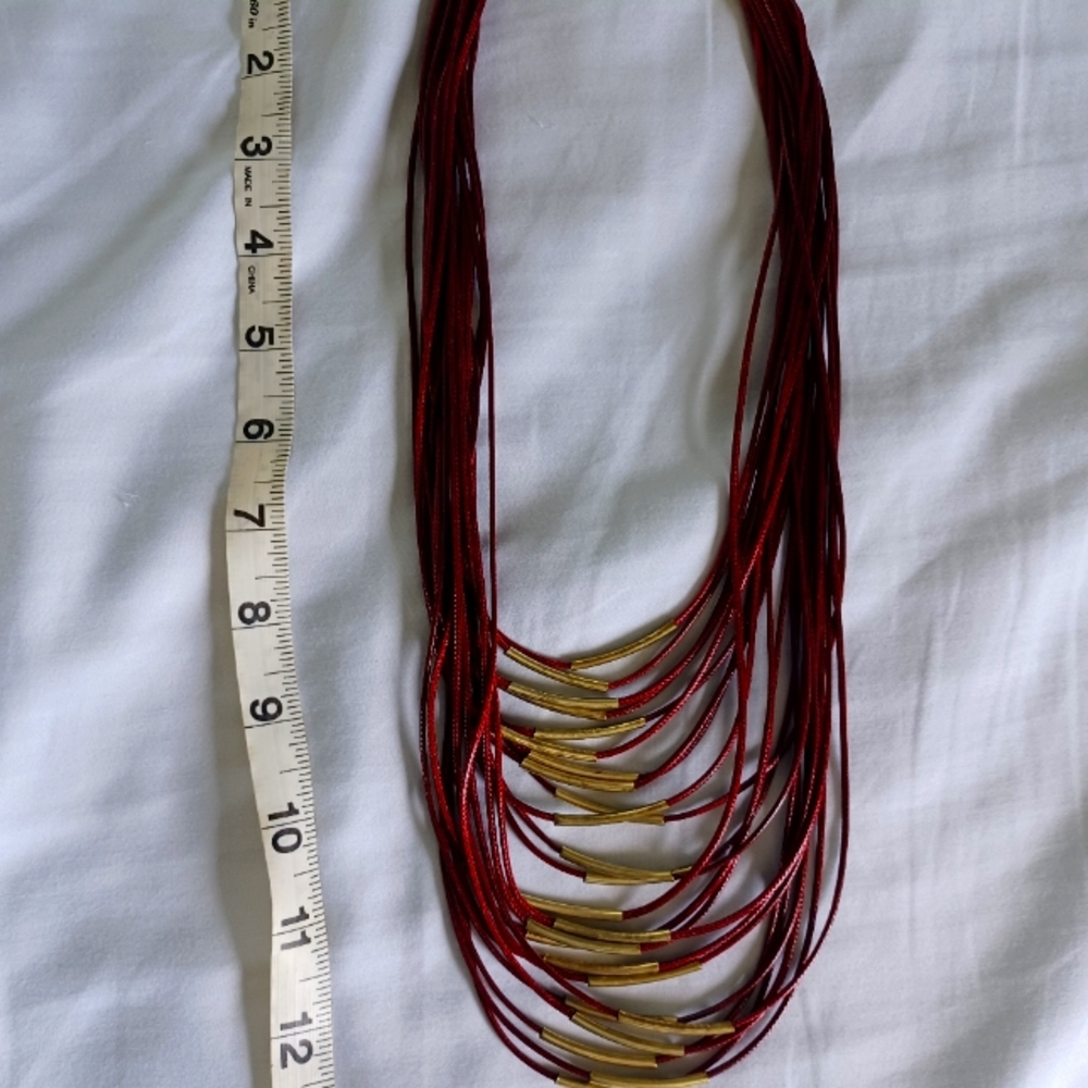 Dark red necklace with gold detail.